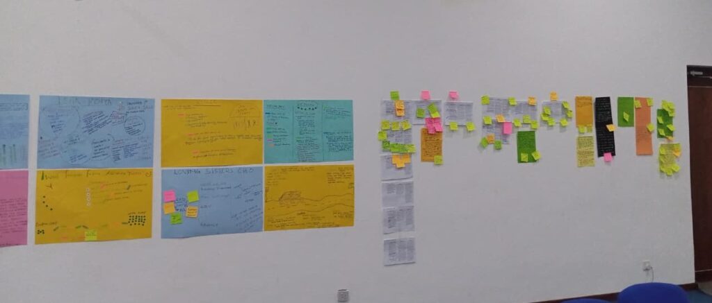 the wall of change made of posters and stickers showcasing the work and achievements of different organisations