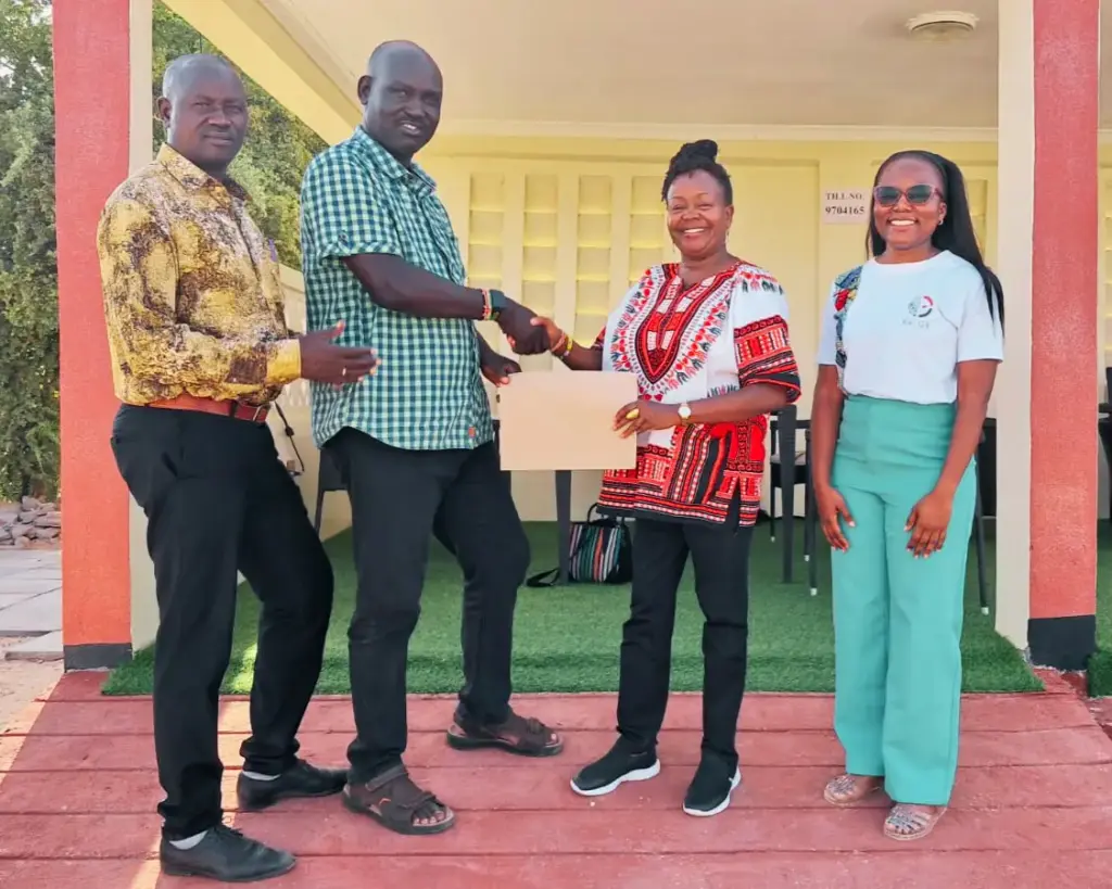 Dr. Grace Githaiga and Mr. Augustine Kai Lopie shake hands after sealing EDACR partnership in Turkana.